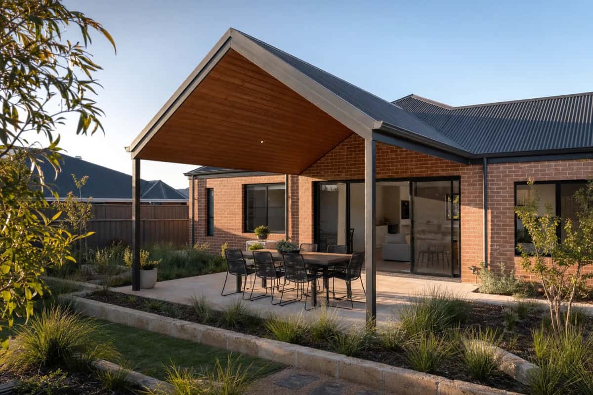 Pitched gable patio roof attached to a brick home, timber-look lining underneath